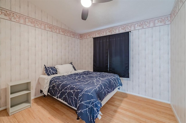 bedroom with ceiling fan and hardwood / wood-style flooring