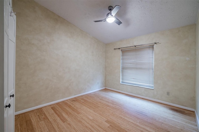 empty room featuring ceiling fan and light wood-type flooring