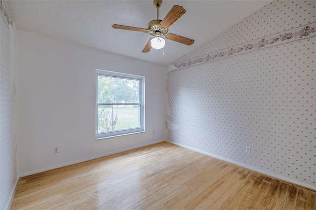 empty room featuring ceiling fan and light hardwood / wood-style floors