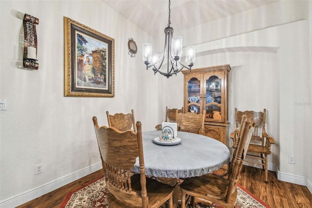 dining space featuring an inviting chandelier and dark hardwood / wood-style flooring