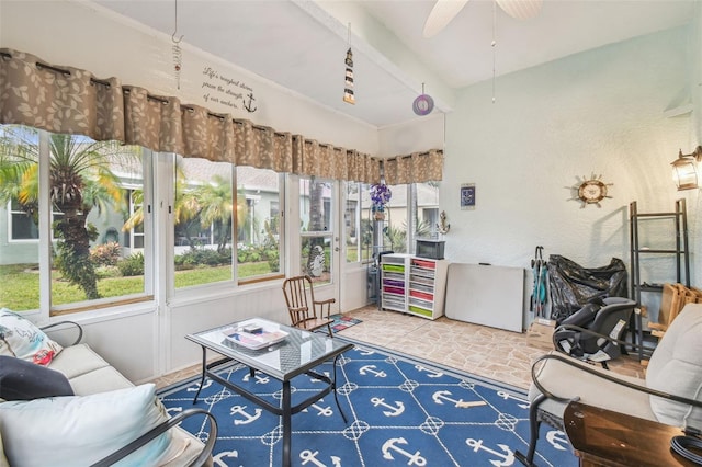 sunroom with a healthy amount of sunlight and ceiling fan