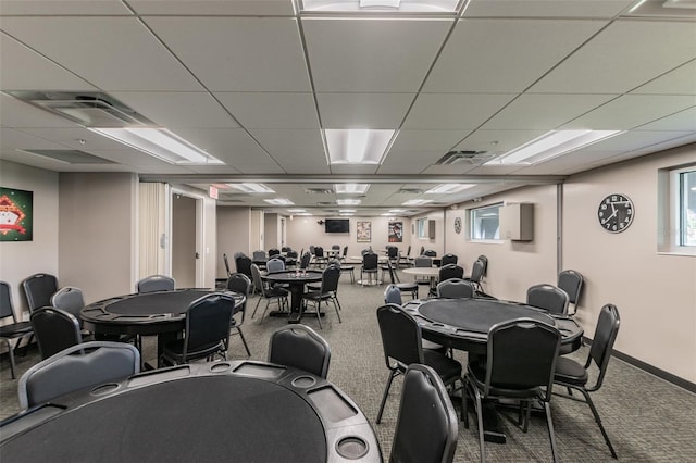 carpeted dining space featuring a drop ceiling