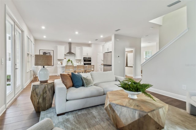 living room with a wealth of natural light and light hardwood / wood-style flooring