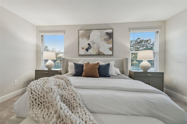 carpeted bedroom featuring multiple windows