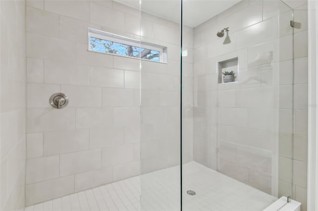 bathroom with a tile shower