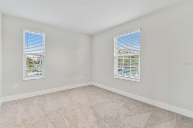 unfurnished room with light colored carpet