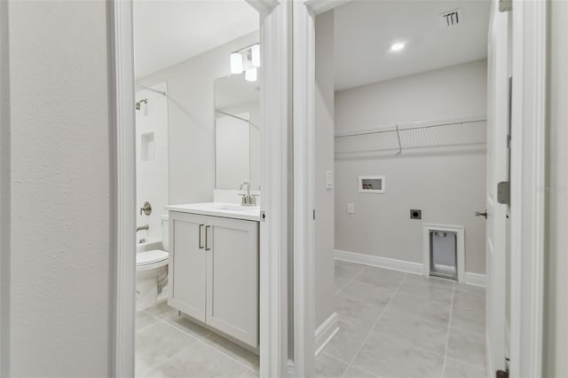 full bathroom featuring toilet, vanity, tile patterned floors, and shower / bath combination