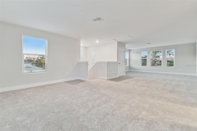 unfurnished room with light carpet and a wealth of natural light