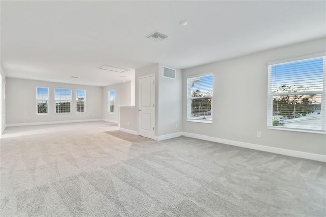 unfurnished living room with light carpet and a wealth of natural light