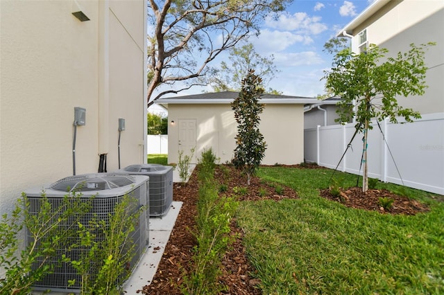 view of home's exterior with central air condition unit and a yard