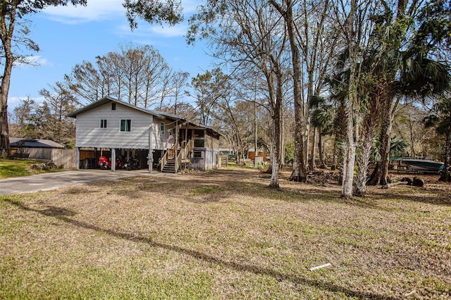 view of side of home with a carport and a yard