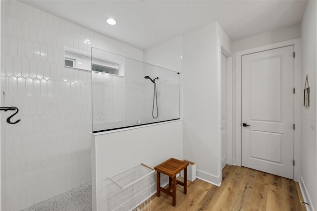 bathroom featuring walk in shower and wood-type flooring