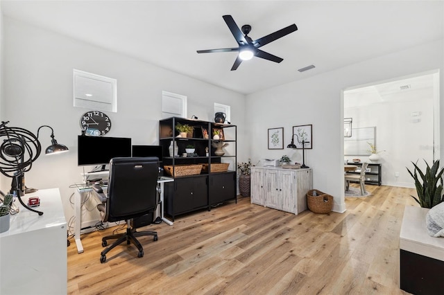 office space with ceiling fan and light hardwood / wood-style floors