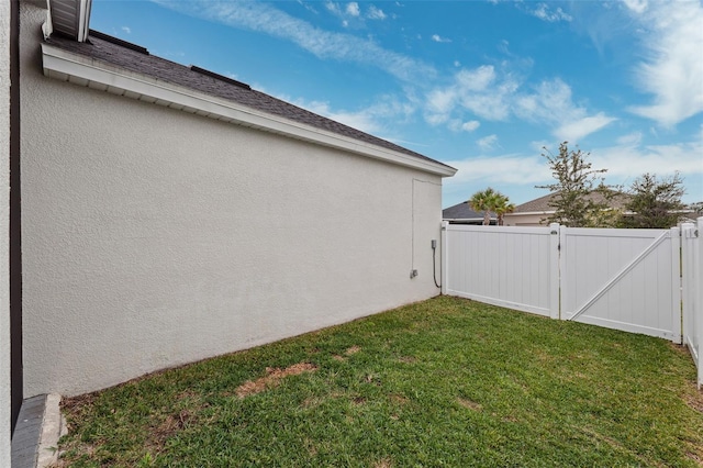 view of side of home featuring a yard