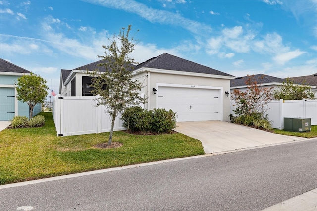 view of front of property featuring a garage and a front lawn