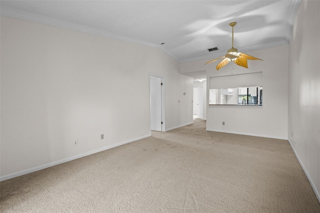 carpeted empty room featuring vaulted ceiling, ceiling fan, and crown molding