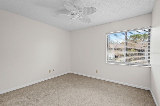 unfurnished room with a textured ceiling, ceiling fan, and carpet flooring