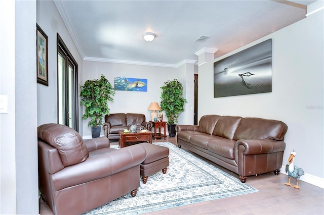 living room with ornate columns and crown molding