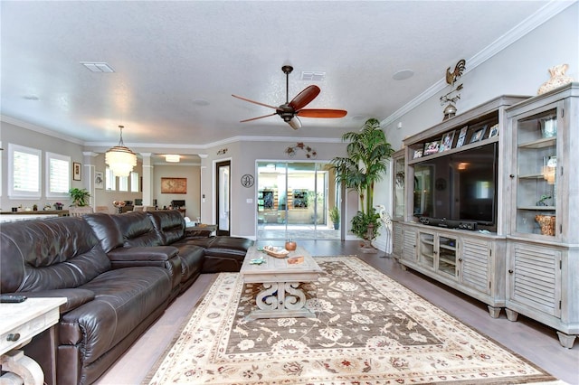 living room featuring ceiling fan, light hardwood / wood-style floors, a textured ceiling, and crown molding