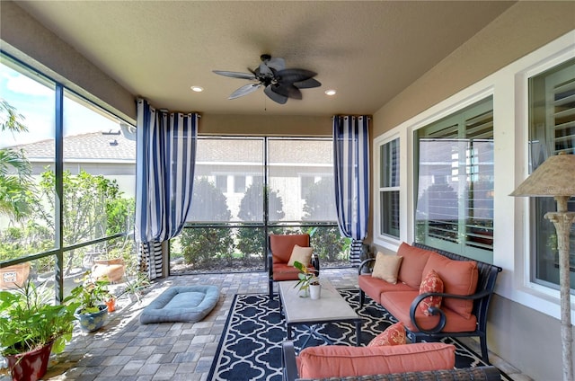 sunroom / solarium featuring ceiling fan