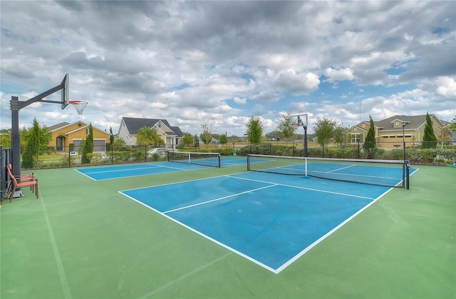 view of tennis court featuring basketball court