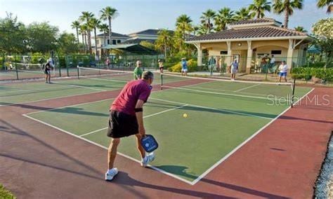 view of tennis court with basketball hoop