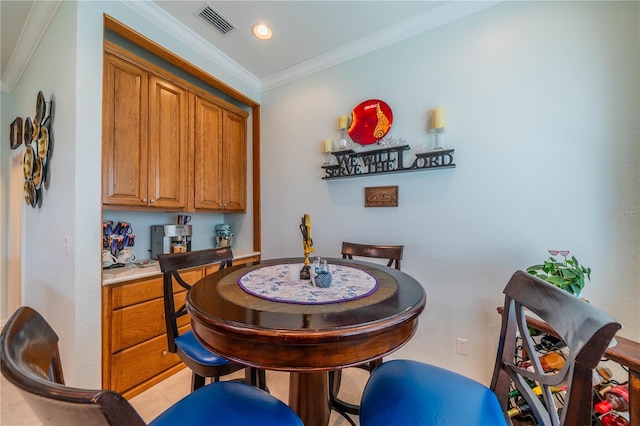 dining room featuring crown molding