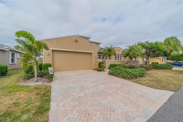 view of front of home with a garage and a front lawn