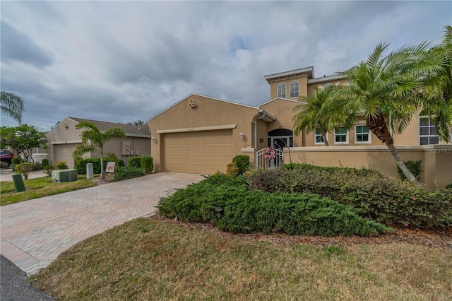 view of front of house featuring a garage and a front lawn