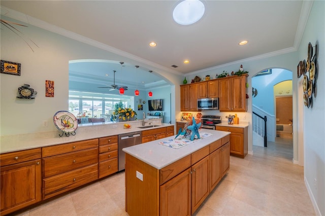 kitchen with sink, ornamental molding, a center island, kitchen peninsula, and stainless steel appliances