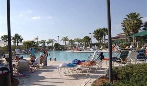 view of swimming pool with a patio, a water view, and a water slide