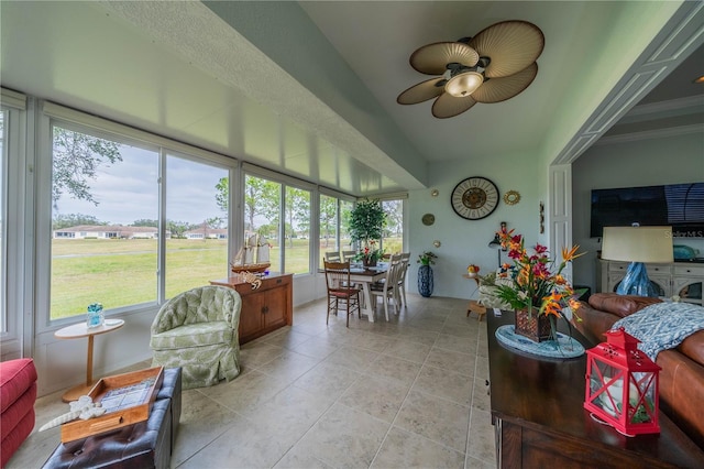 sunroom featuring ceiling fan