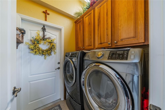 washroom featuring cabinets, tile patterned flooring, and washer and dryer