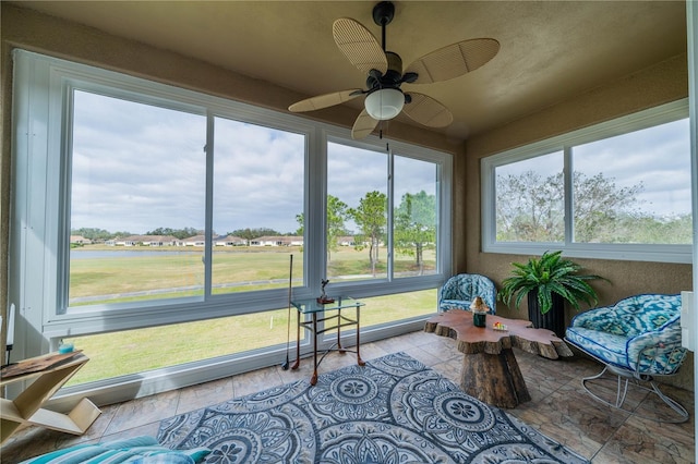 sunroom featuring plenty of natural light and ceiling fan