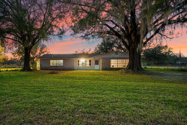 single story home featuring a yard