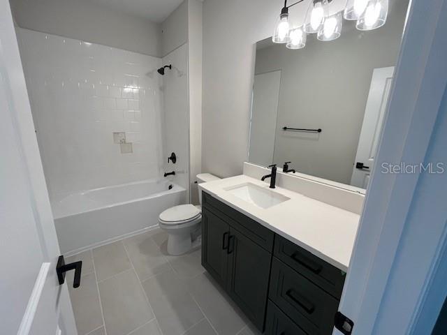 full bath with toilet, washtub / shower combination, and vanity