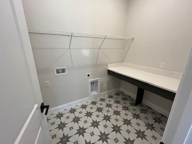 washroom with laundry area, baseboards, hookup for an electric dryer, light floors, and washer hookup