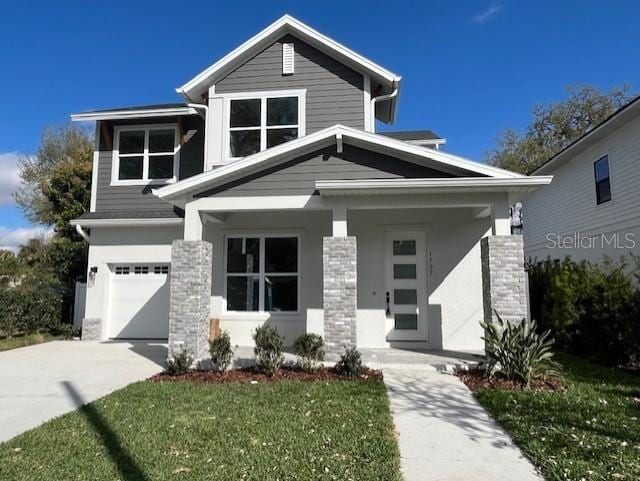 view of front of property with a garage, driveway, and a front yard