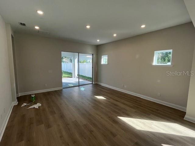 empty room featuring recessed lighting, visible vents, and baseboards