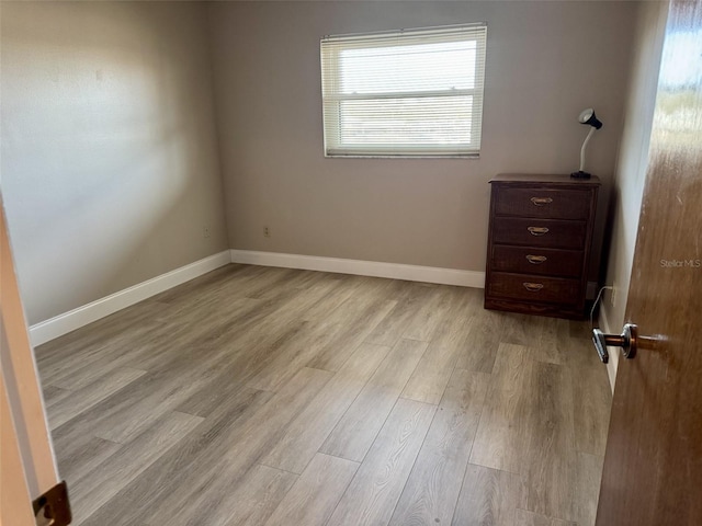 spare room featuring light hardwood / wood-style flooring