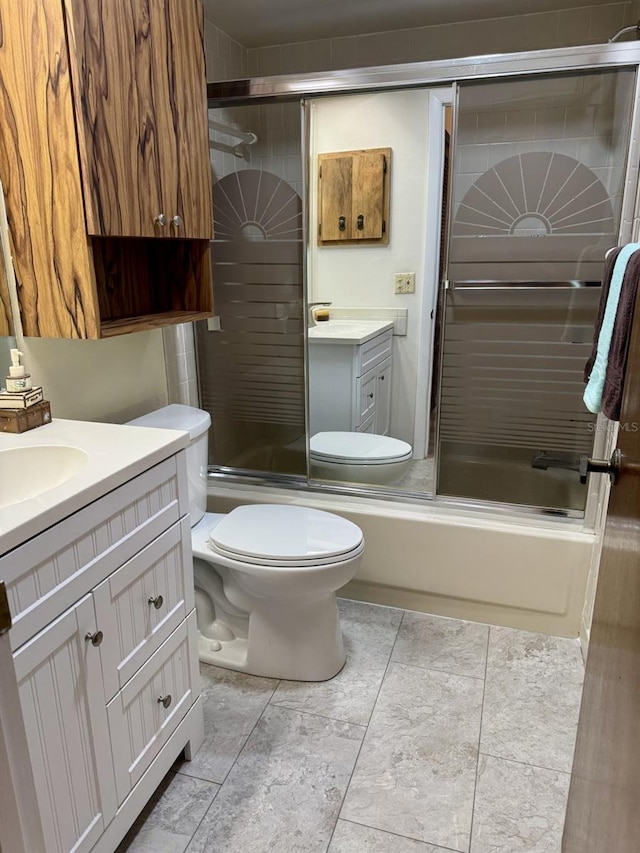 full bathroom with toilet, vanity, and bath / shower combo with glass door