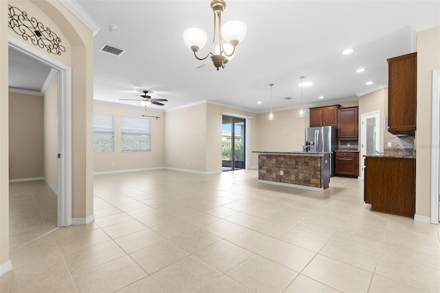 kitchen with crown molding, hanging light fixtures, light tile patterned floors, and ceiling fan with notable chandelier