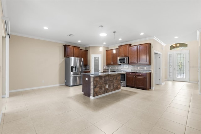 kitchen with pendant lighting, backsplash, ornamental molding, stainless steel appliances, and a center island with sink