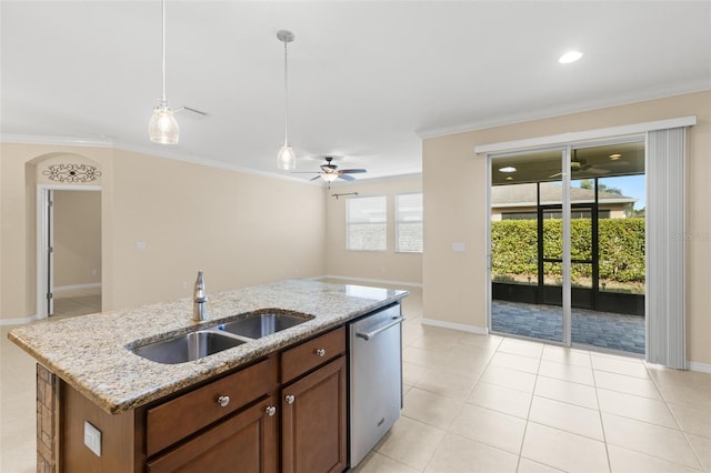 kitchen with light stone counters, sink, dishwasher, and a center island with sink