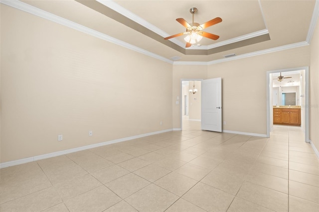 spare room featuring crown molding, light tile patterned floors, ceiling fan, and a tray ceiling