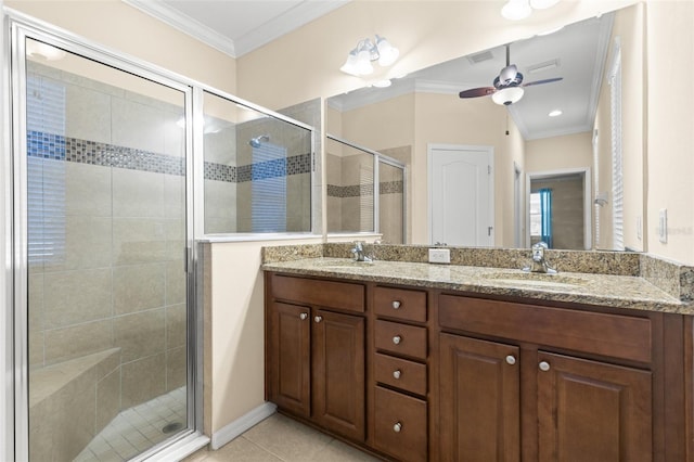 bathroom with crown molding, a shower with door, ceiling fan, vanity, and tile patterned floors