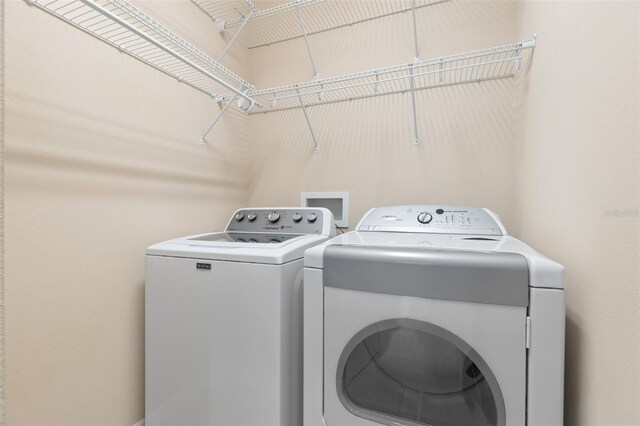 clothes washing area featuring independent washer and dryer