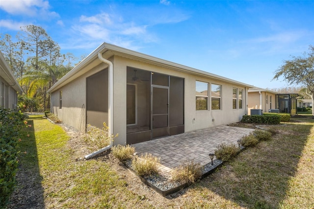 back of property featuring a yard and a patio