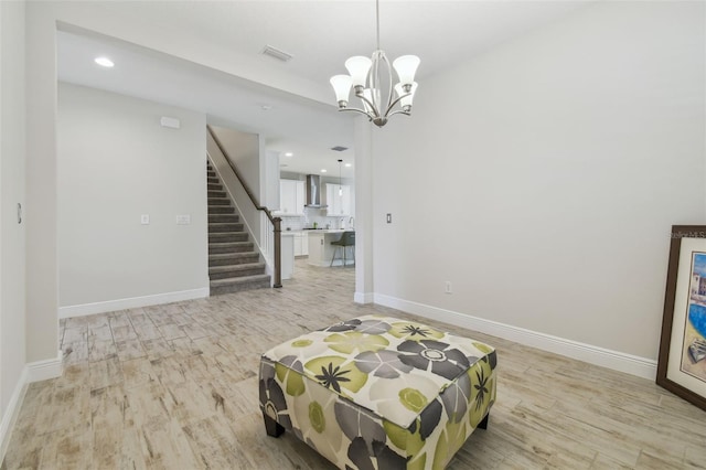 interior space featuring an inviting chandelier and light wood-type flooring