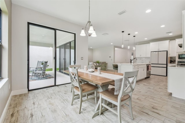 dining area featuring light hardwood / wood-style floors and sink